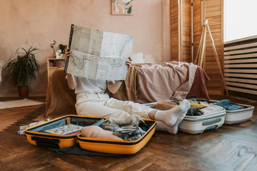 pexels-photo-7368269-7368269 Person packing suitcases with a map in a cozy bedroom, preparing for a journey.